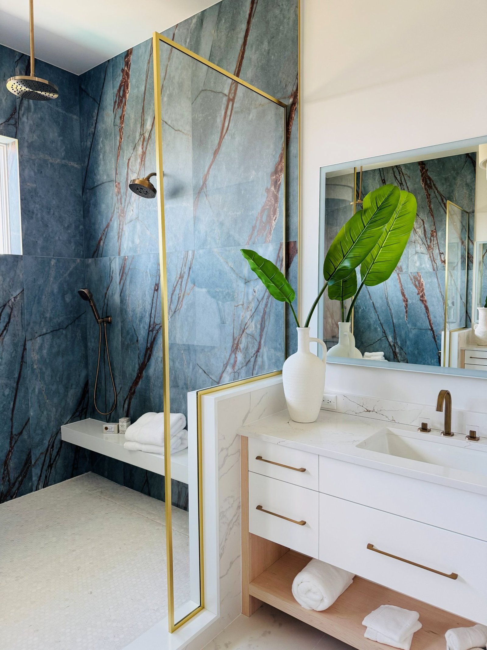 Custom architectural glass panel with brushed gold frame